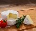 Italian tomino cheese on a wooden chopping board, italian appetizer