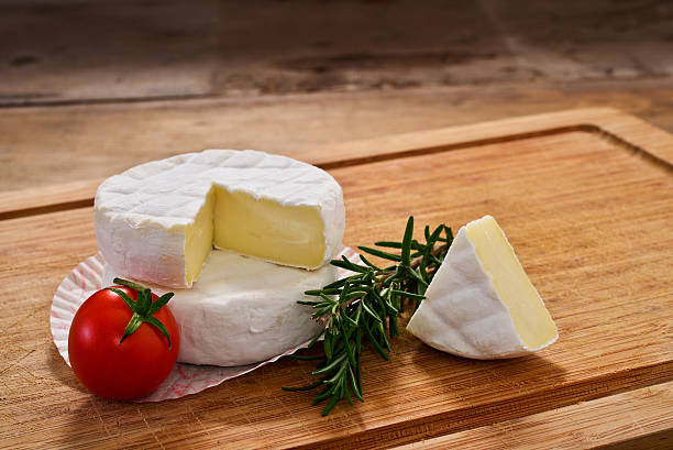 Italian tomino cheese on a wooden chopping board, italian appetizer